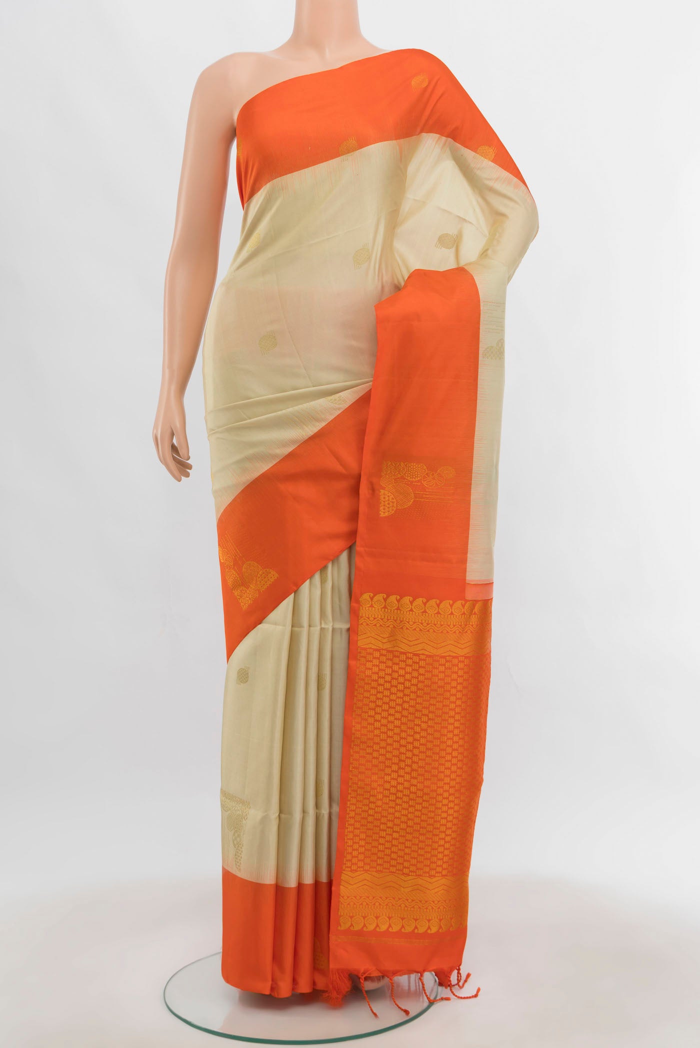 Cream Soft Silk Saree with Zari Butta on the body and Zari Border.  displayed on a mannequin