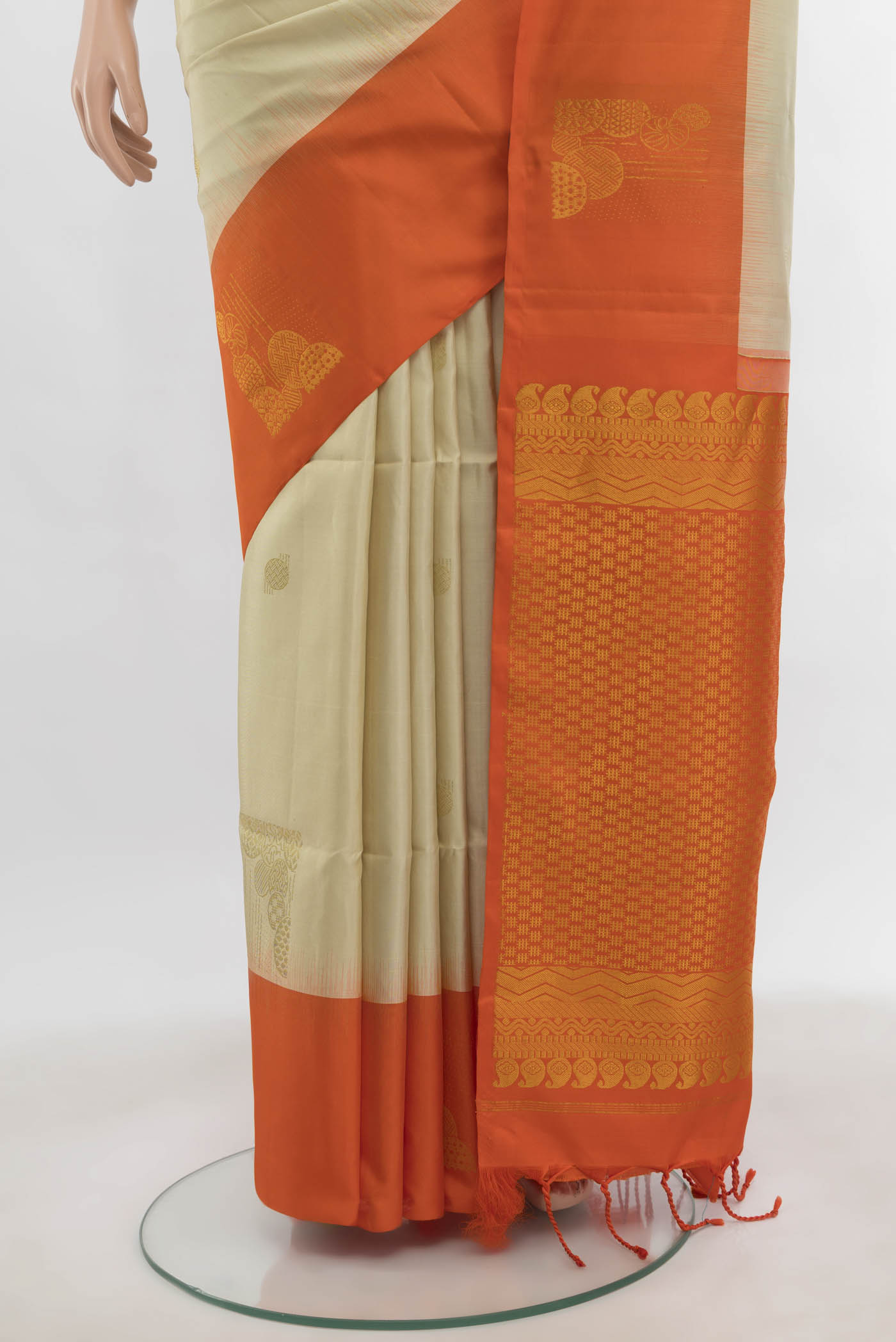 Pleats and pallu of Cream Soft Silk Saree with Zari Butta on the body and Zari Border. 