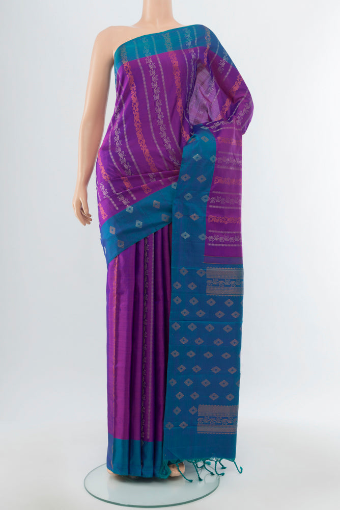 Purple Kanchipuram Silk Saree with Zari Butta on the body and Silk Border.  displayed on a mannequin