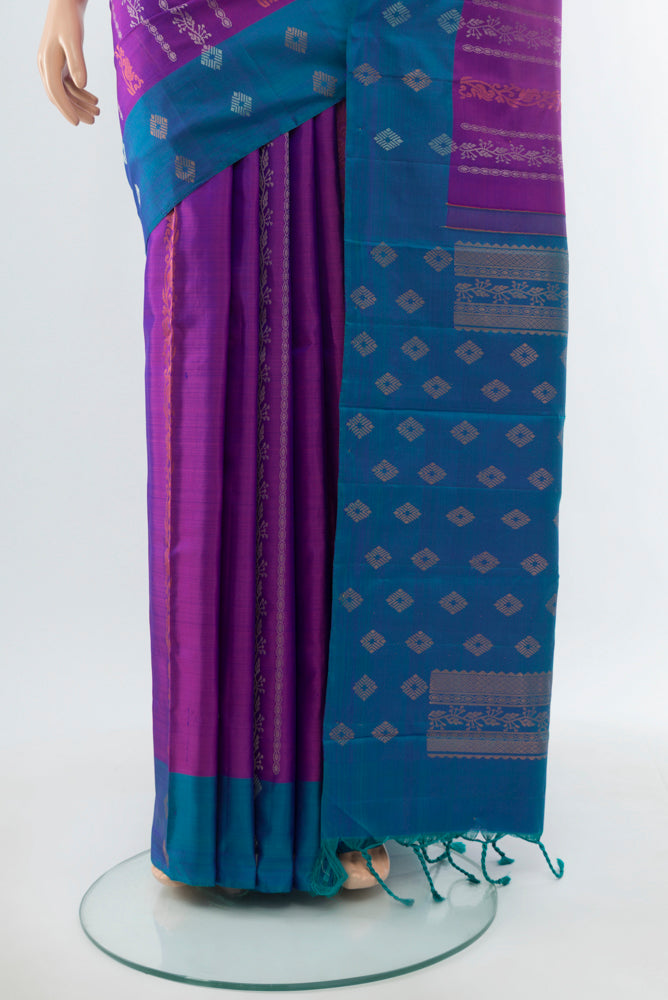 Pleats and pallu of Purple Kanchipuram Silk Saree with Zari Butta on the body and Silk Border. 
