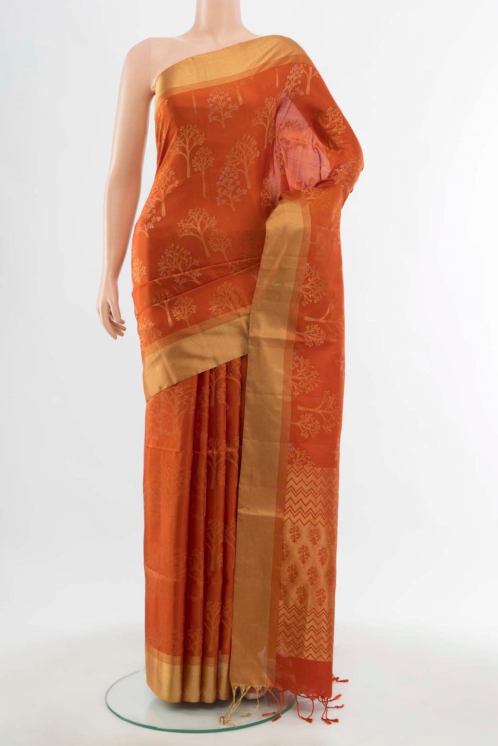 Rust Soft Silk Saree with Zari Butta on the body and Silk Border displayed on a mannequin