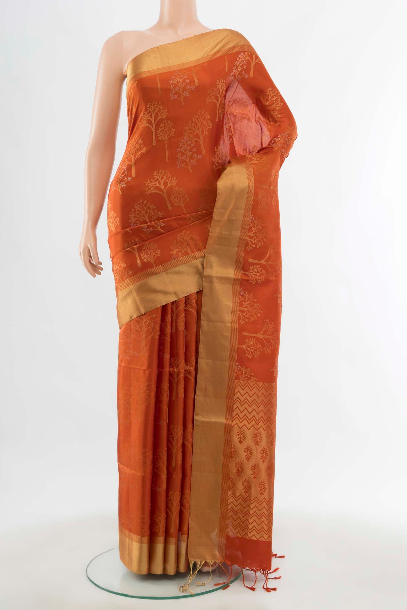 Rust Soft Silk Saree with Zari Butta on the body and Silk Border displayed on a mannequin