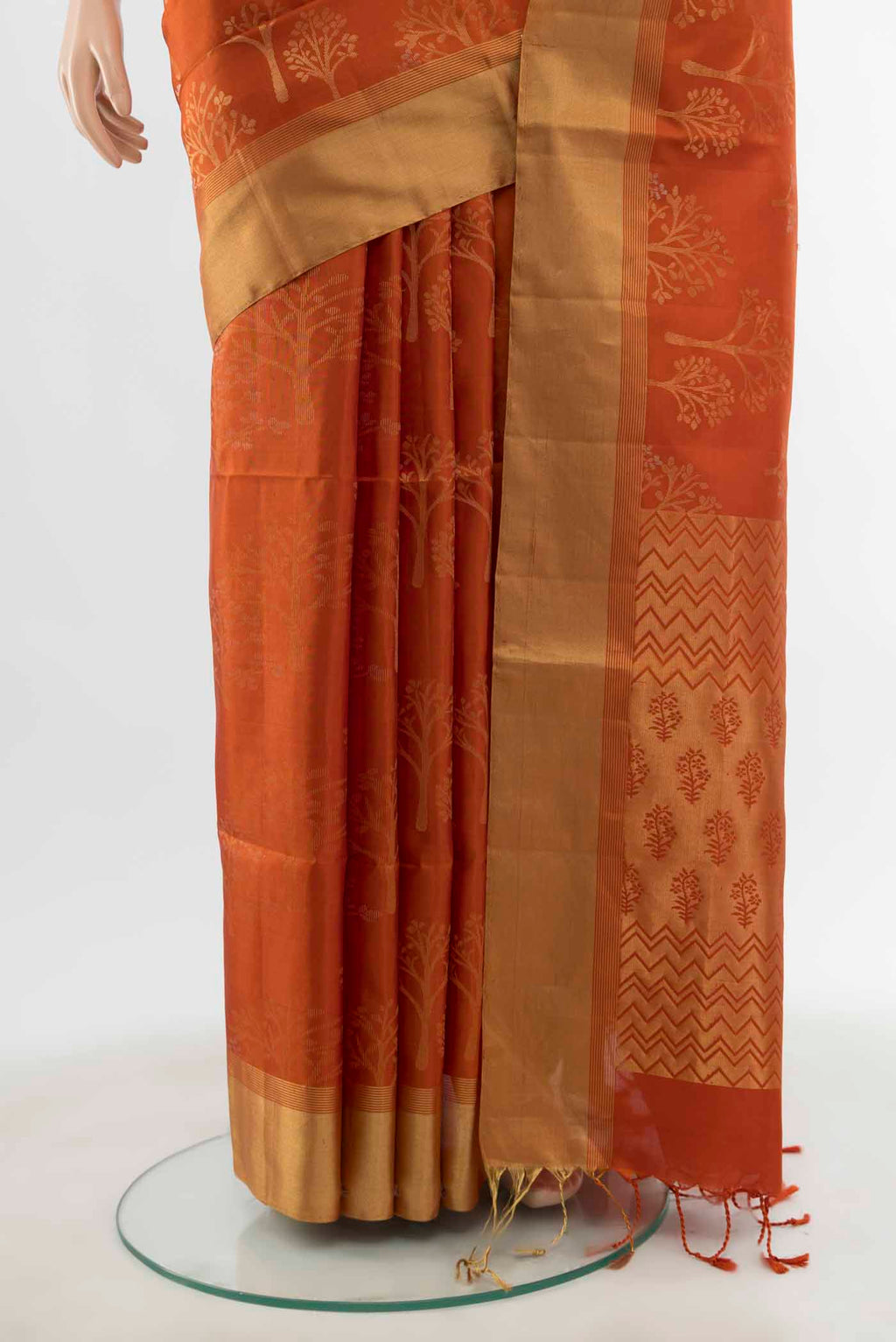Pleats and pallu of Rust Soft Silk Saree with Zari Butta on the body and Silk Border