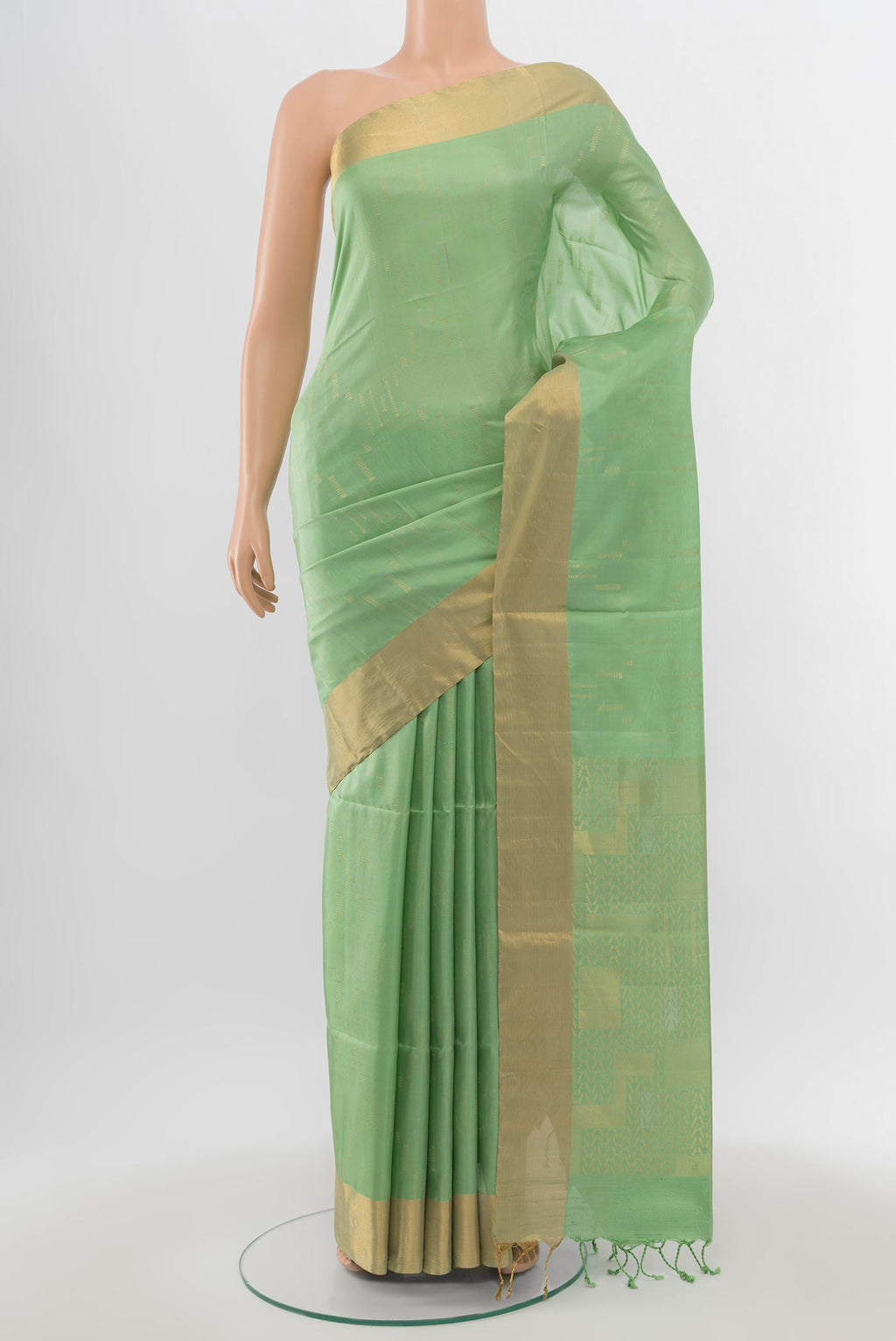 Pista Green Soft Silk Saree with Zari Butta on the body and Zari Border.  displayed on a mannequin