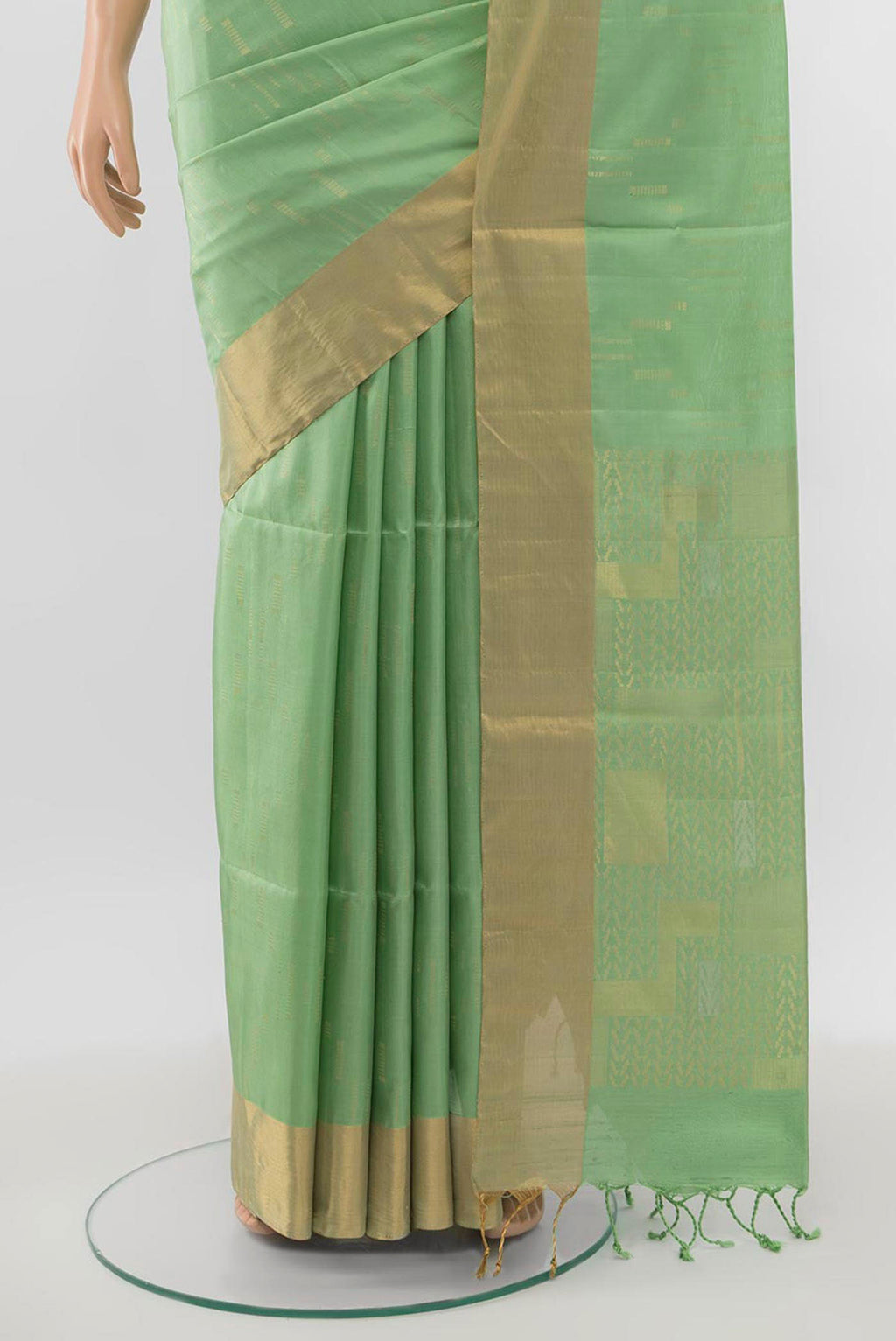 Pleats and pallu of Pista Green Soft Silk Saree with Zari Butta on the body and Zari Border. 