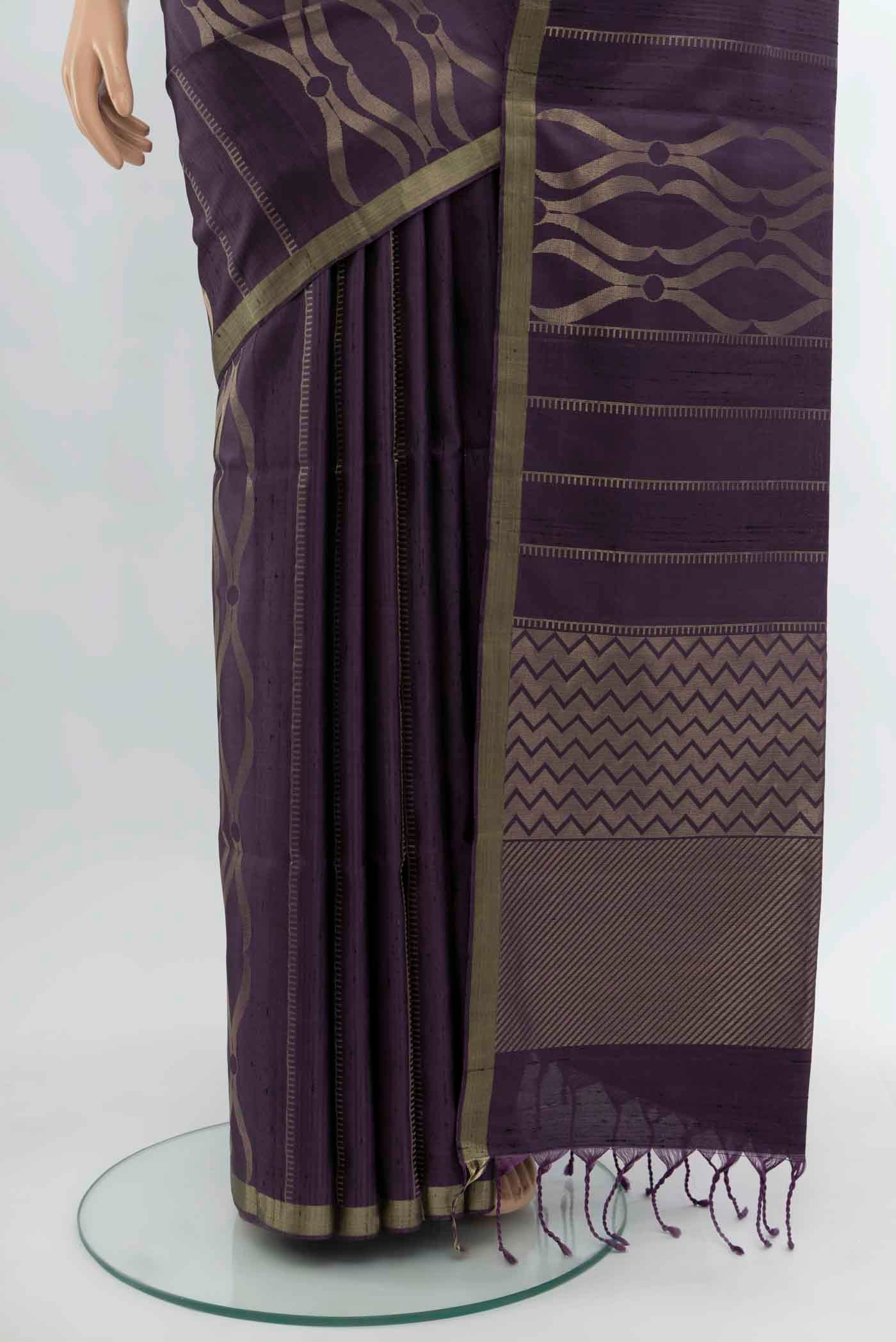 Pleats and pallu of Purple Soft Silk Saree with Zari Butta on the body and Silk Border. 