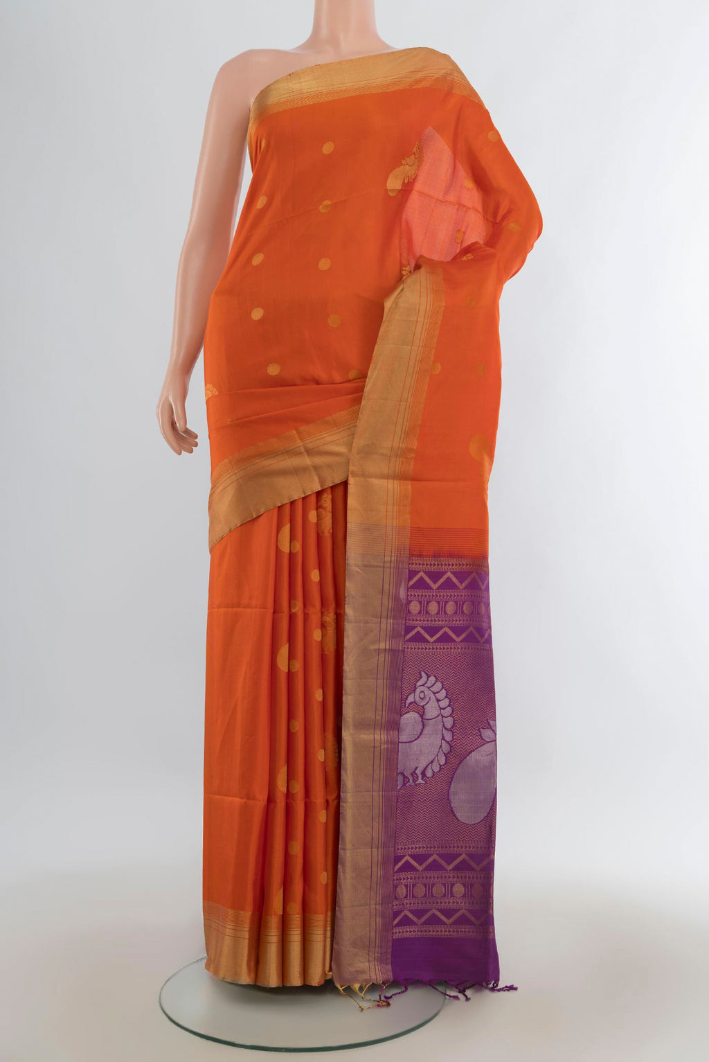 Pure Silk Orange Soft Saree with Zari Butta on the body and Zari Border.  displayed on a mannequin