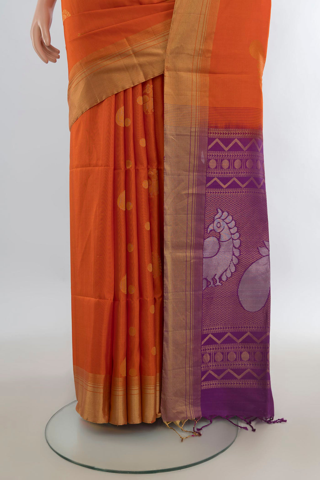 Pleats and pallu of Pure Silk Orange Soft Saree with Zari Butta on the body and Zari Border. 