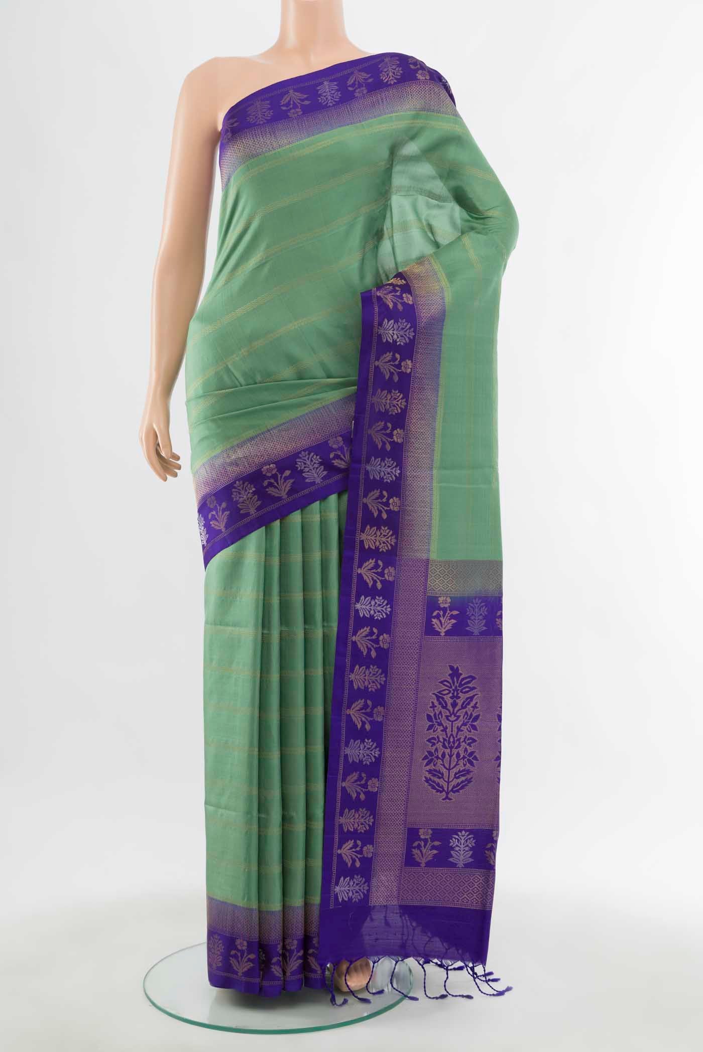 Light Green Soft Silk Saree with Zari Butta on the body and Silk Border displayed on a mannequin