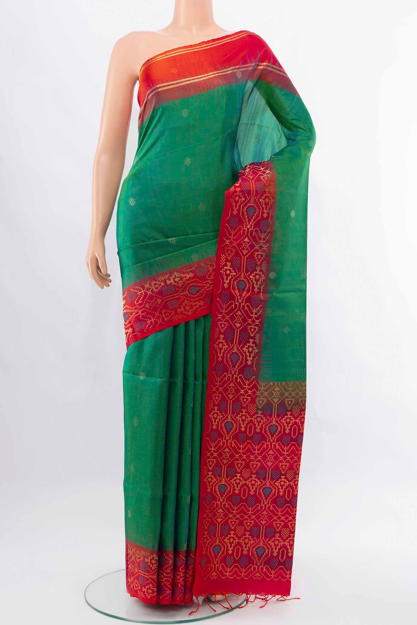 Light Green Soft Silk Saree with Zari Butta on the body and Silk Border displayed on a mannequin