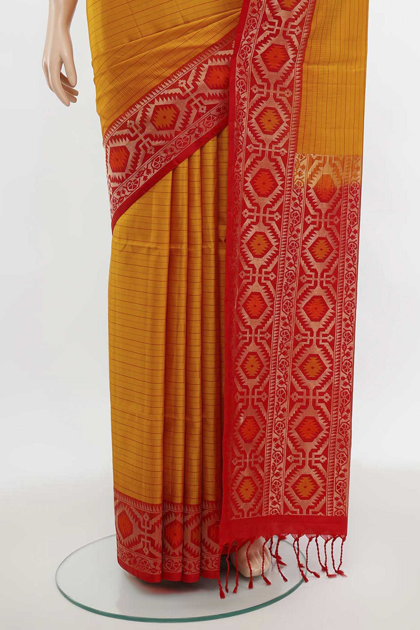 Pleats and pallu of Mustard Soft Silk Saree with Zari Butta on the body and Silk Border. 