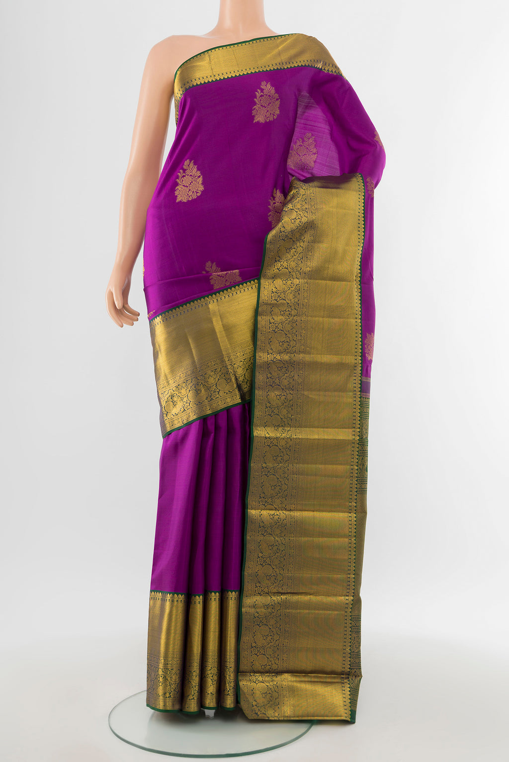 Pure Silk Pure Zari Magenta Kanchipuram Saree with Zari Butta on the body and Silk Border.  displayed on a mannequin