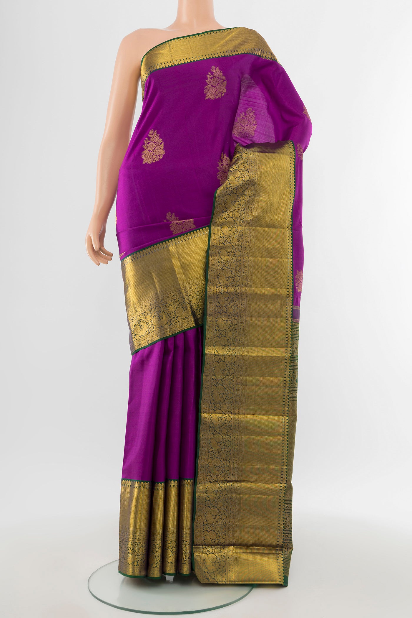 Pure Silk Pure Zari Magenta Kanchipuram Saree with Zari Butta on the body and Silk Border.  displayed on a mannequin