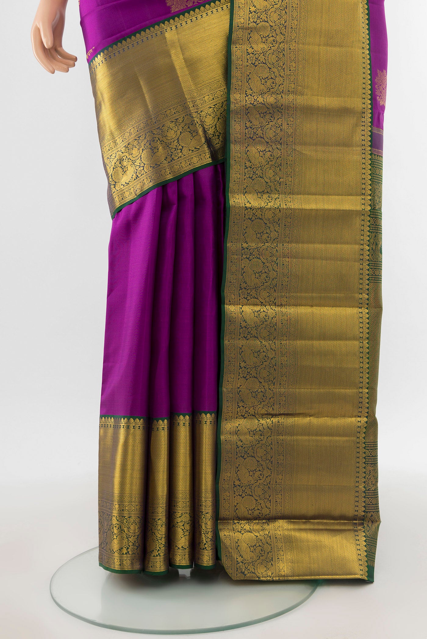 Pleats and pallu of Pure Silk Pure Zari Magenta Kanchipuram Saree with Zari Butta on the body and Silk Border. 