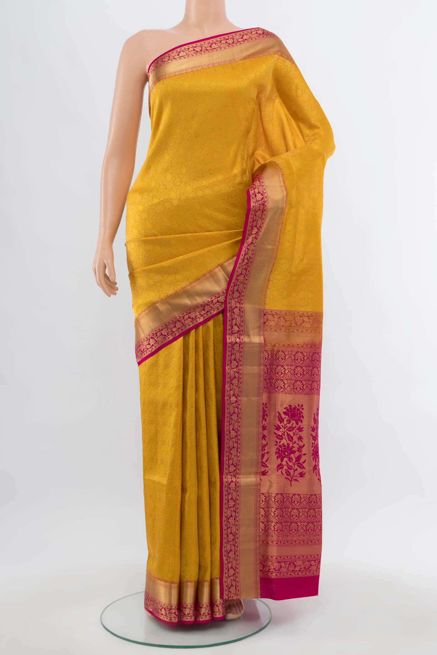 Yellow Soft Silk Saree with Zari Butta on the body and Silk Border.  displayed on a mannequin