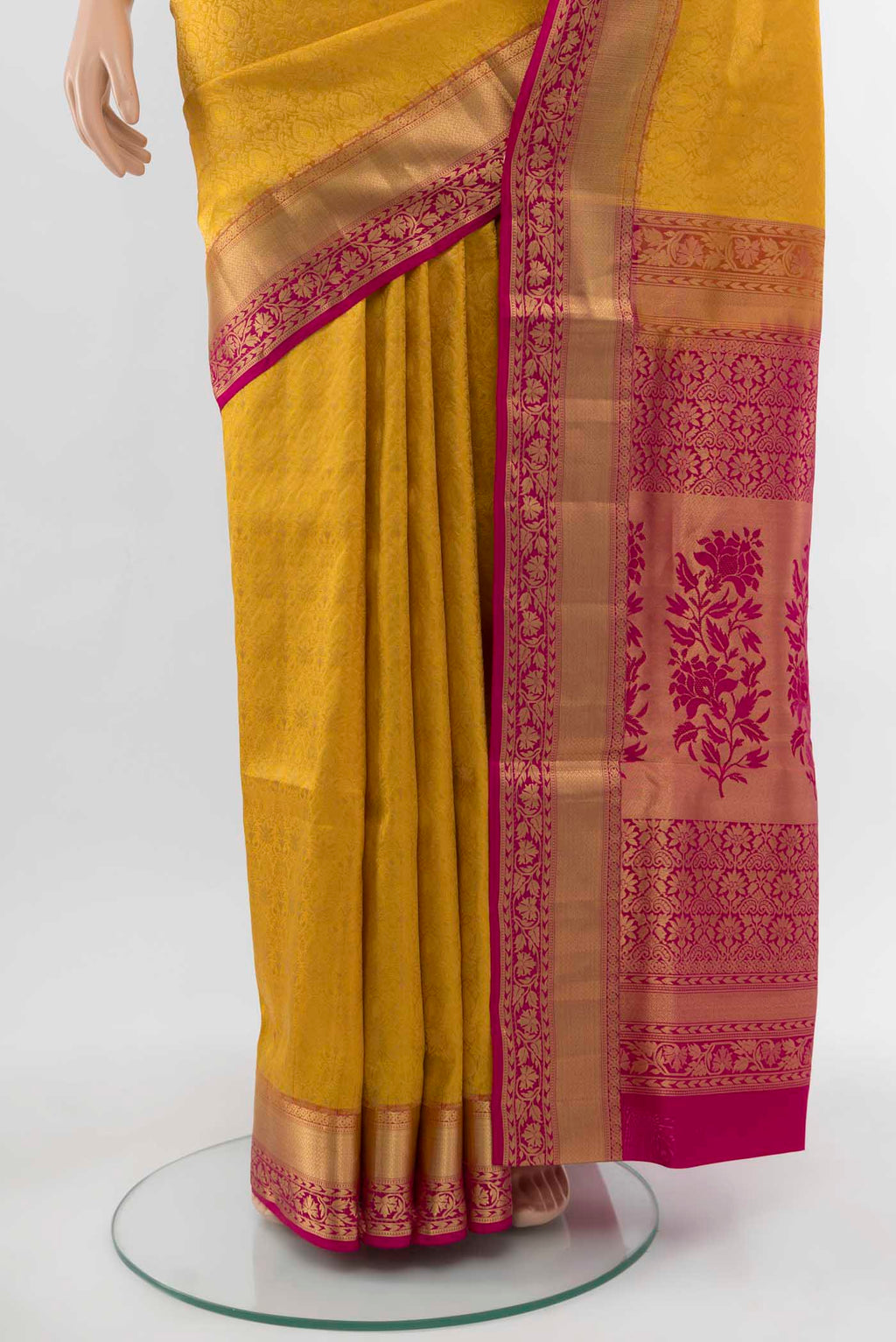 Pleats and pallu of Yellow Soft Silk Saree with Zari Butta on the body and Silk Border. 