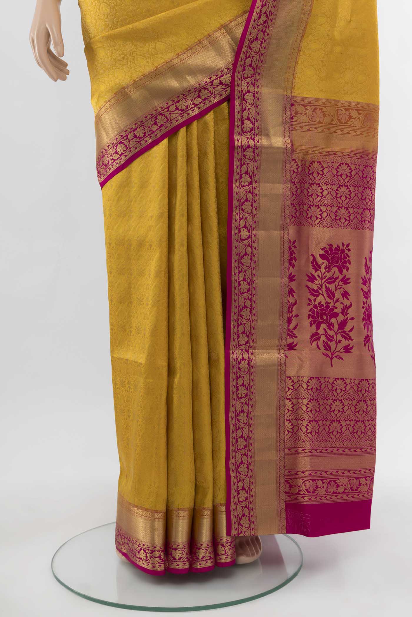 Pleats and pallu of Yellow Soft Silk Saree with Zari Butta on the body and Silk Border. 