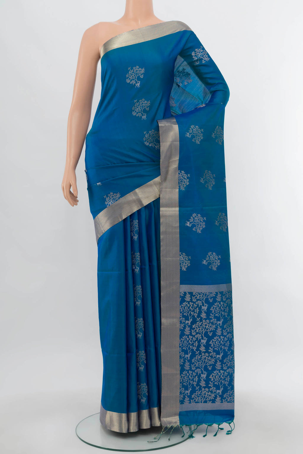 Light Blue Soft Silk Saree with Zari Butta on the body and Silk Border.  displayed on a mannequin