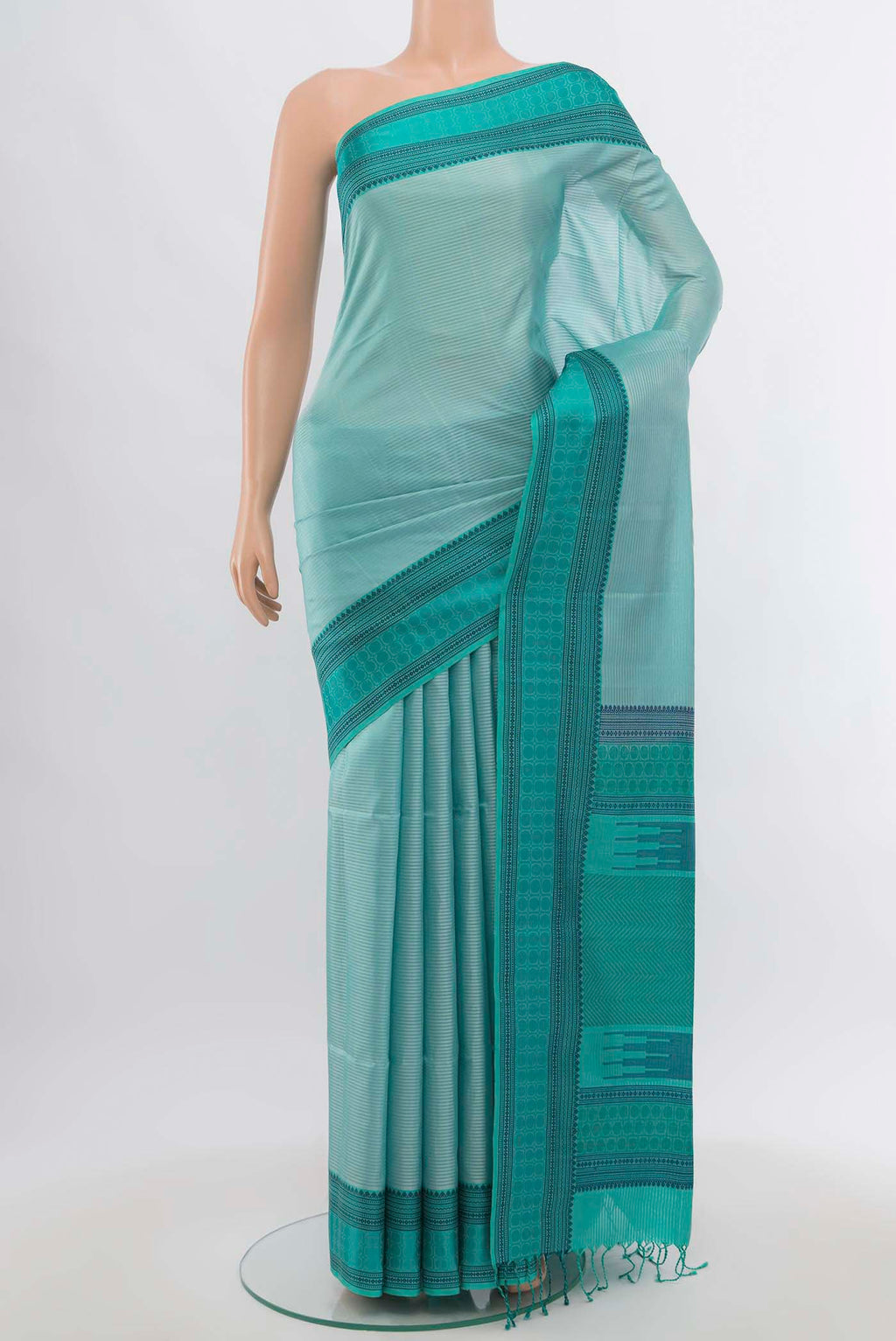 Light Blue Soft Silk Saree with Zari Butta on the body and Silk Border.  displayed on a mannequin