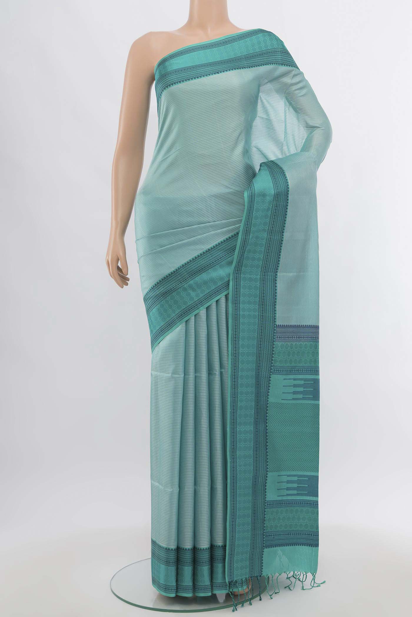 Light Blue Soft Silk Saree with Zari Butta on the body and Silk Border.  displayed on a mannequin