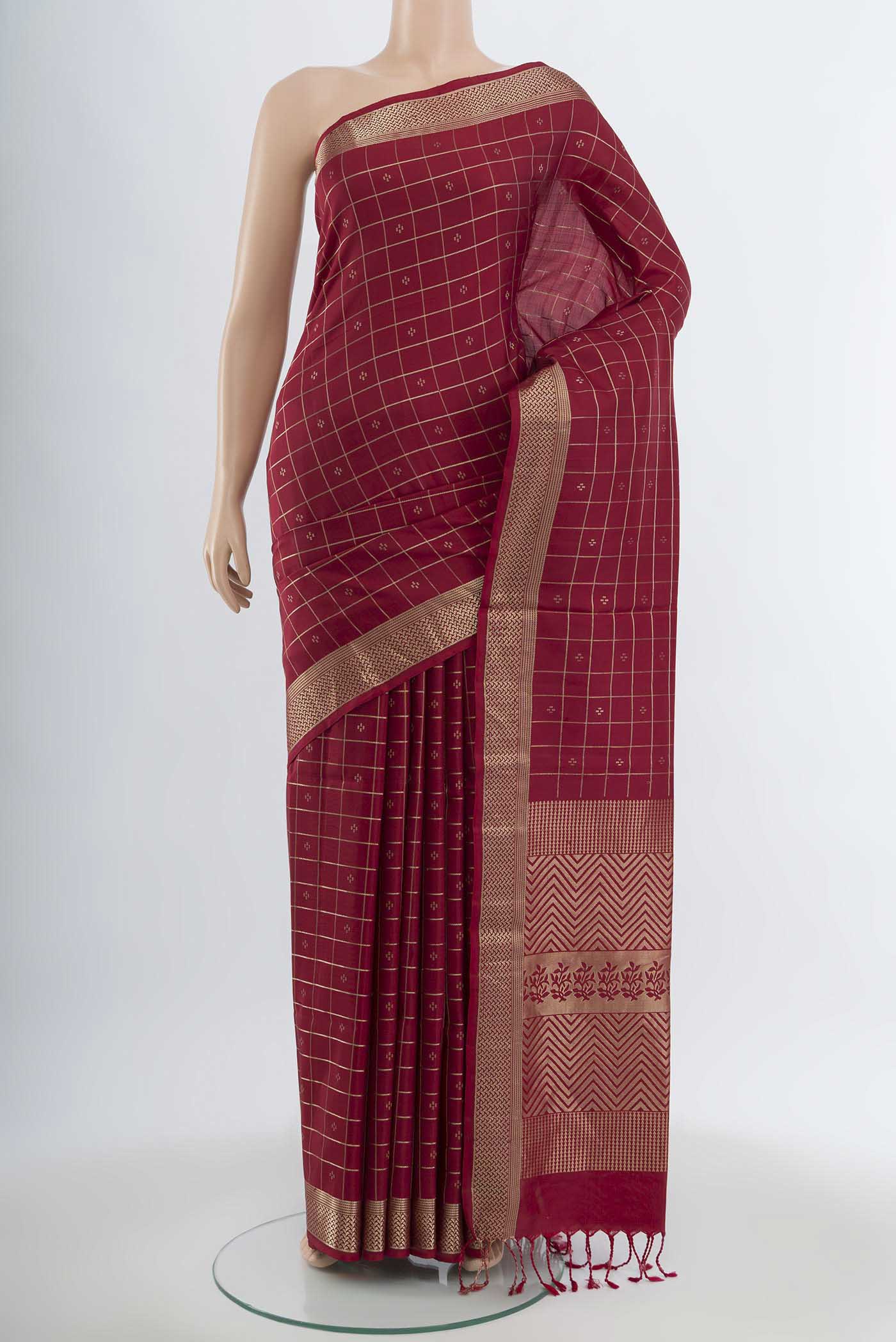 Maroon Soft Silk Saree with Zari Butta on the body and Silk Border.  displayed on a mannequin