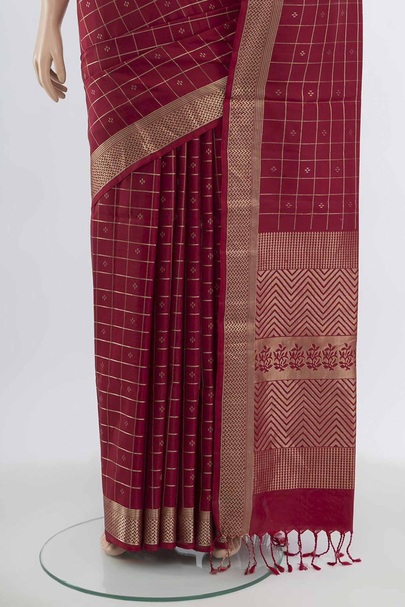Pleats and pallu of Maroon Soft Silk Saree with Zari Butta on the body and Silk Border. 