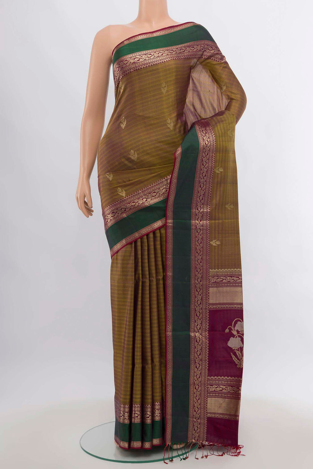 Mehandi Green Soft Silk Saree with Zari Butta on the body and Silk Border.  displayed on a mannequin