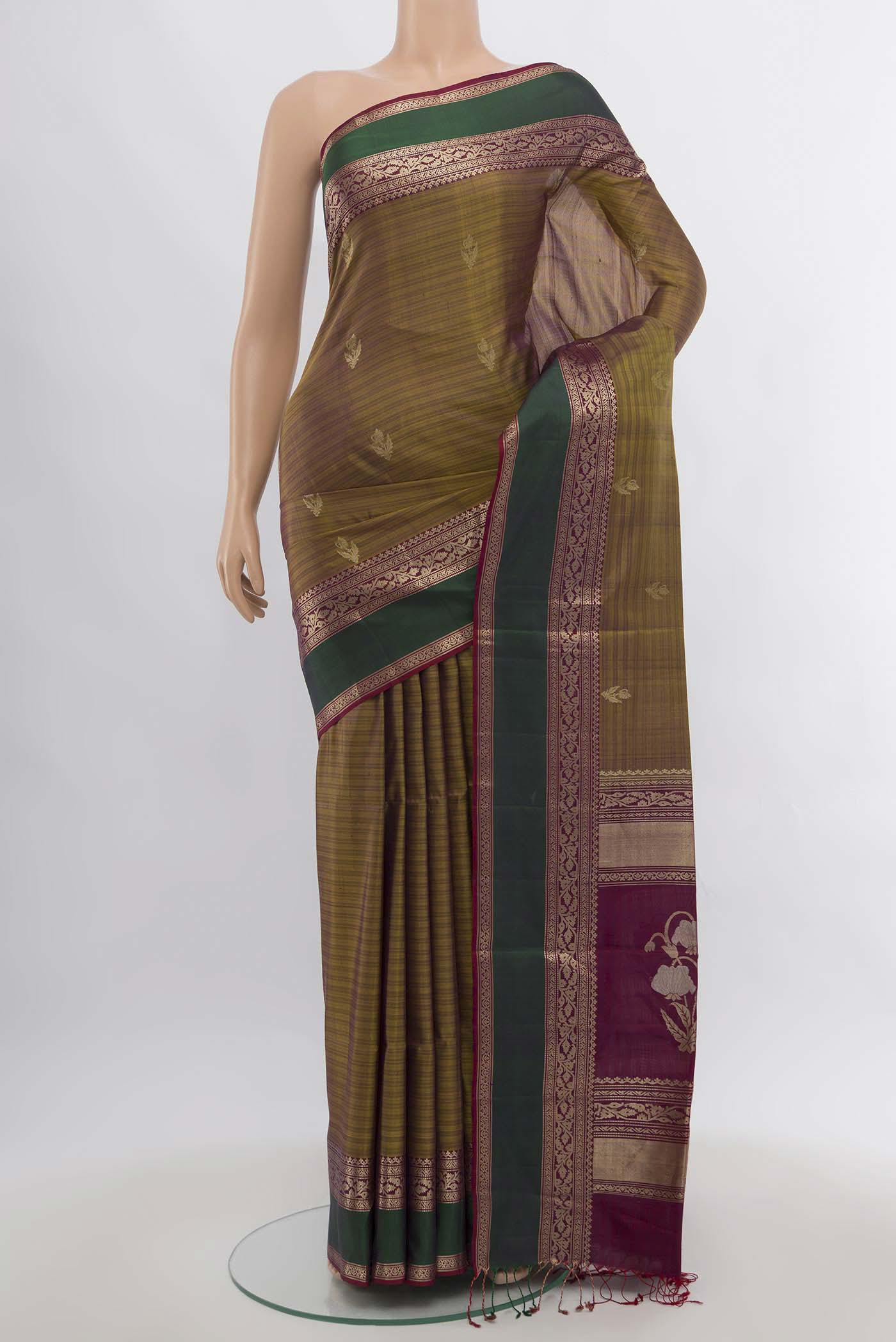 Mehandi Green Soft Silk Saree with Zari Butta on the body and Silk Border.  displayed on a mannequin