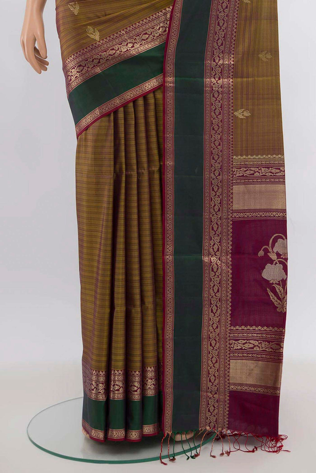 Pleats and pallu of Mehandi Green Soft Silk Saree with Zari Butta on the body and Silk Border. 
