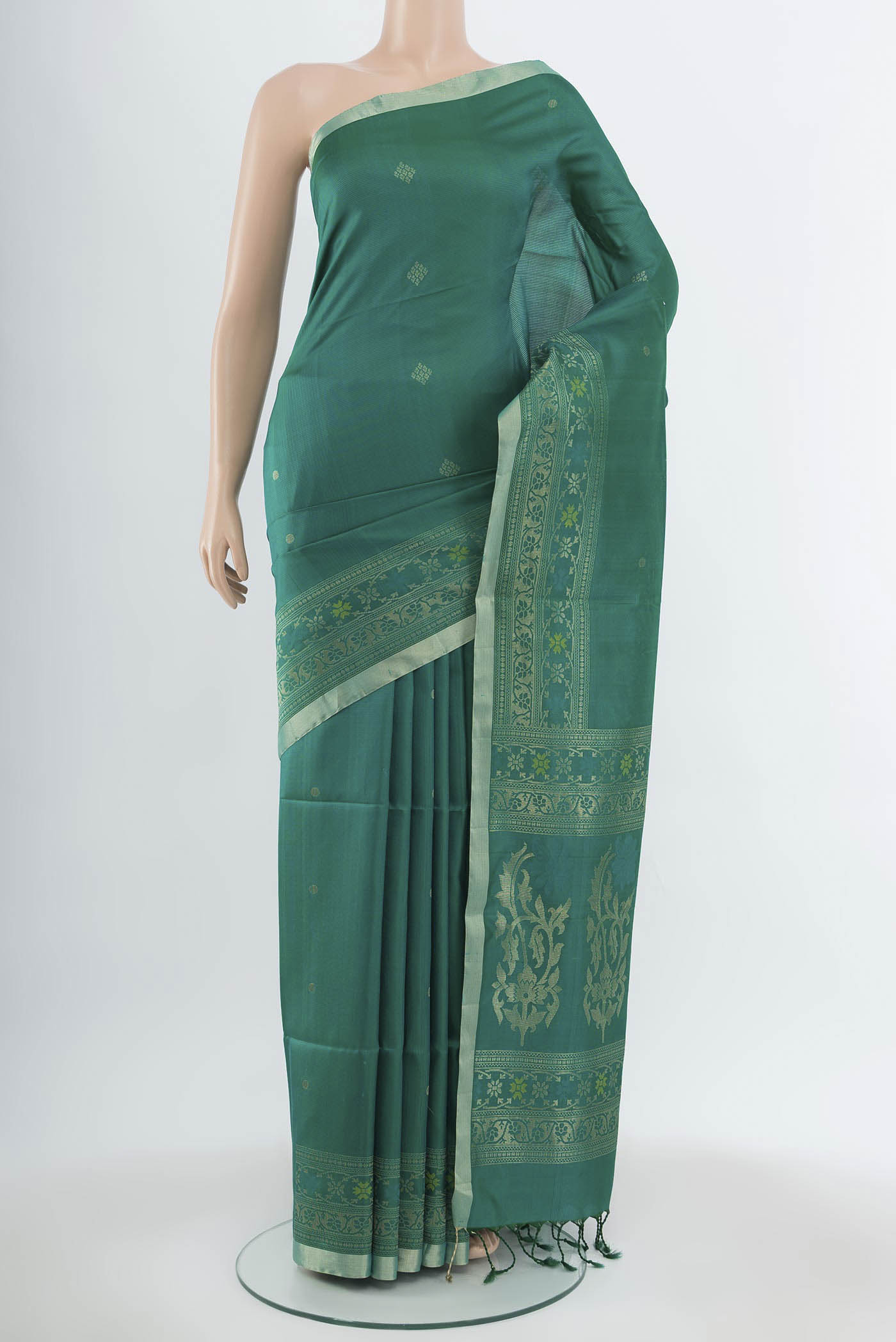 Light Green Soft Silk Saree with Zari Butta on the body and Silk Border.  displayed on a mannequin