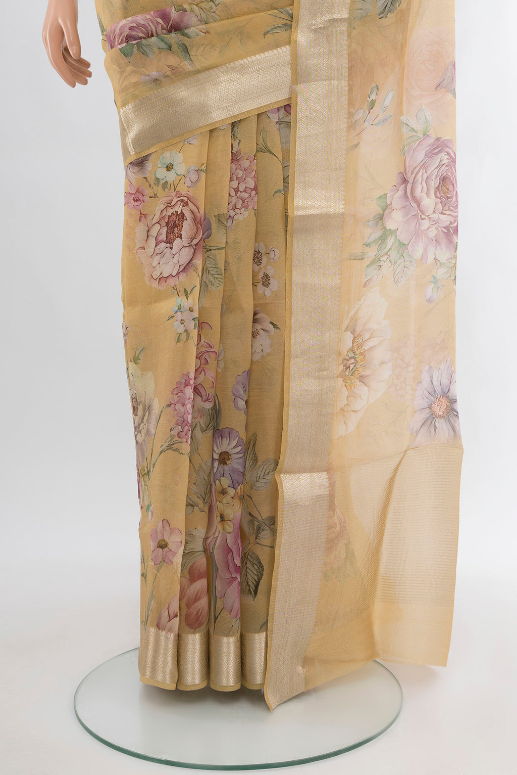 Pleats and pallu of Sandal Organza Silk Saree with Floral Print on the body and Zari Border. 