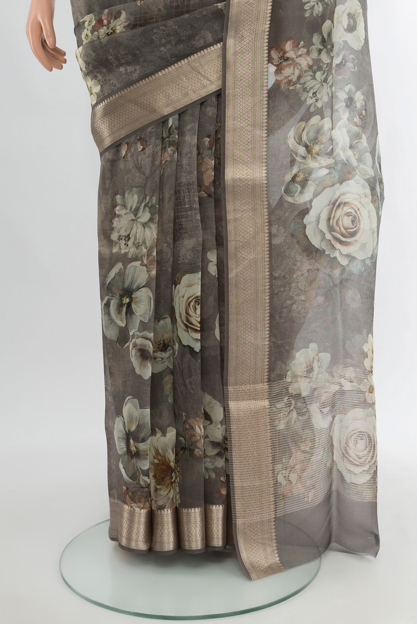 Pleats and pallu of Davys Grey Organza Silk Saree with Floral Print on the body and Zari Border. 