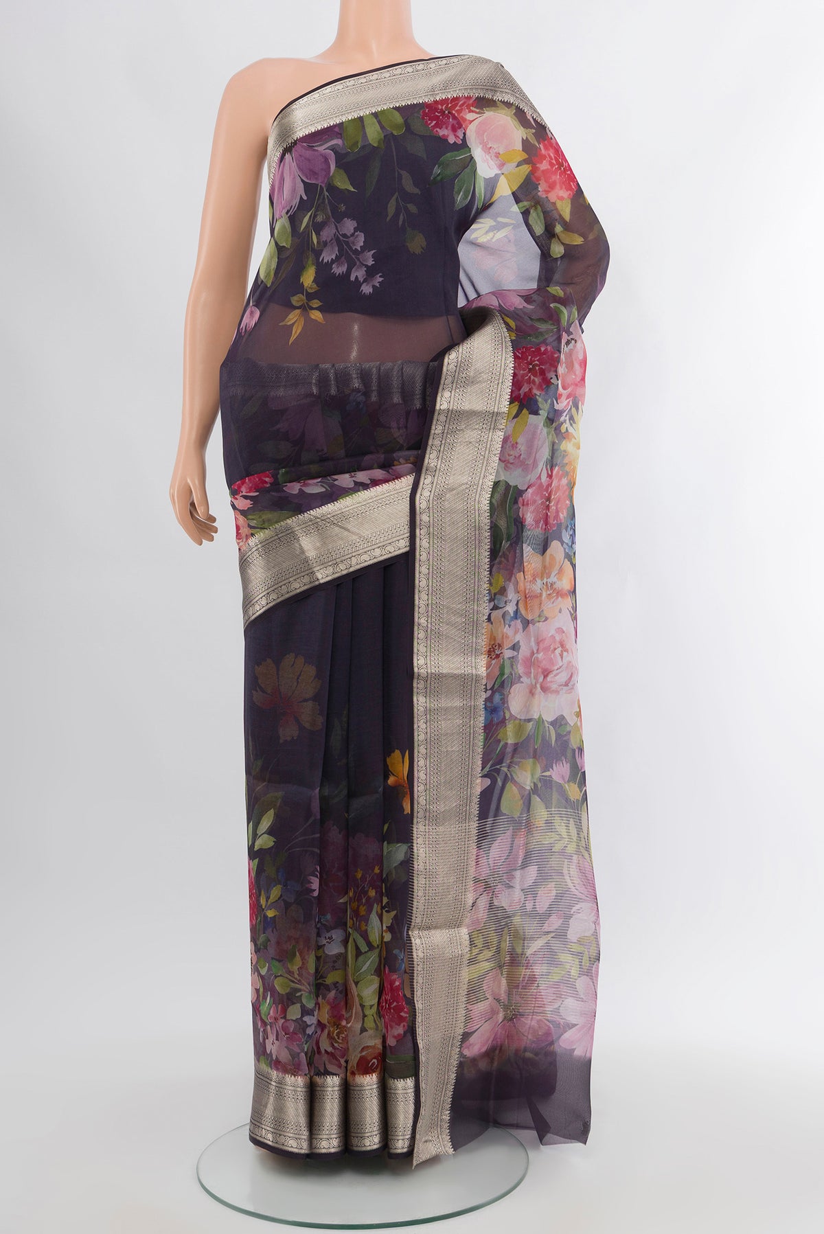 Navy Blue Organza Silk Saree with Floral Print on the body and Zari Border.  displayed on a mannequin