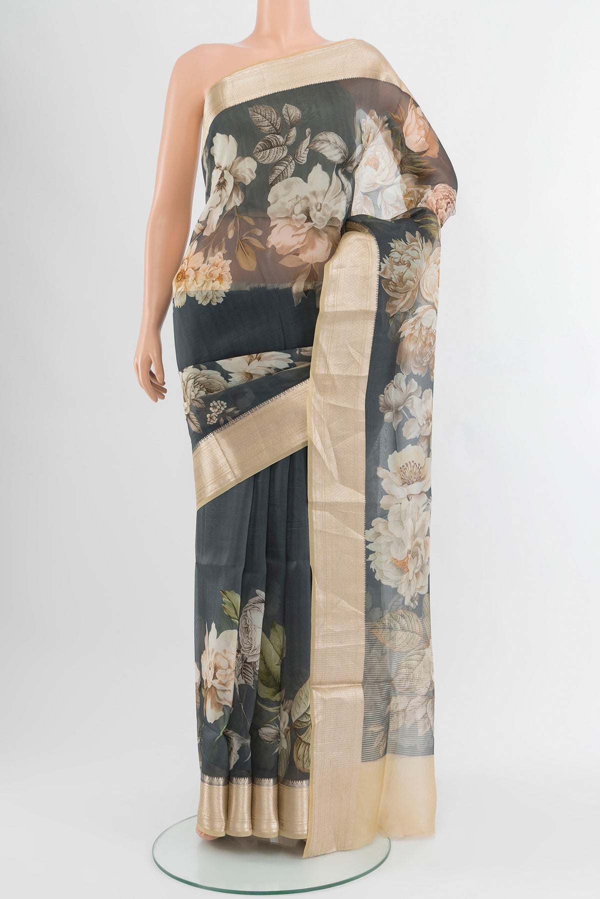 Grey Organza Silk Saree with Floral Print on the body and Zari Border.  displayed on a mannequin