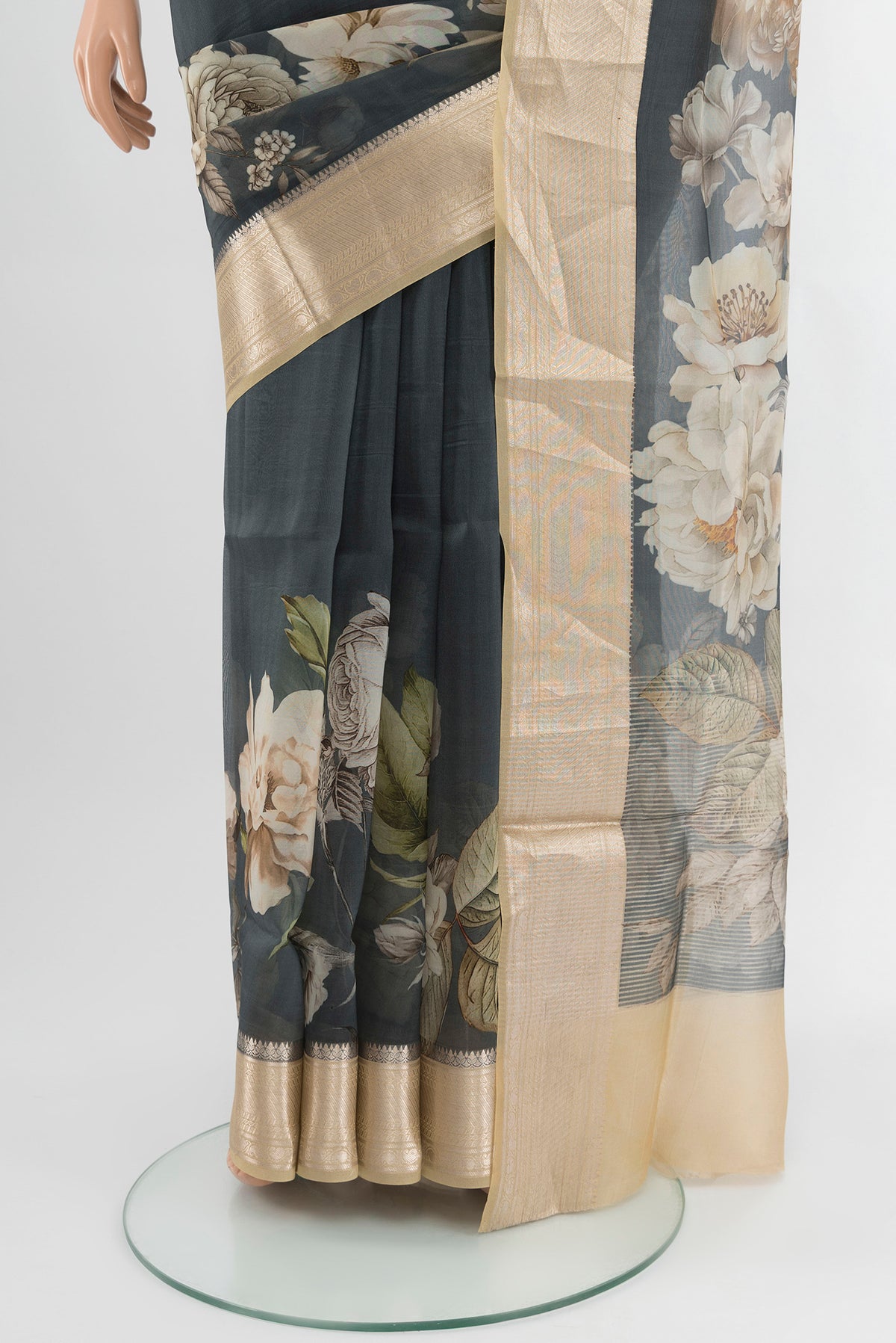 Pleats and pallu of Grey Organza Silk Saree with Floral Print on the body and Zari Border. 