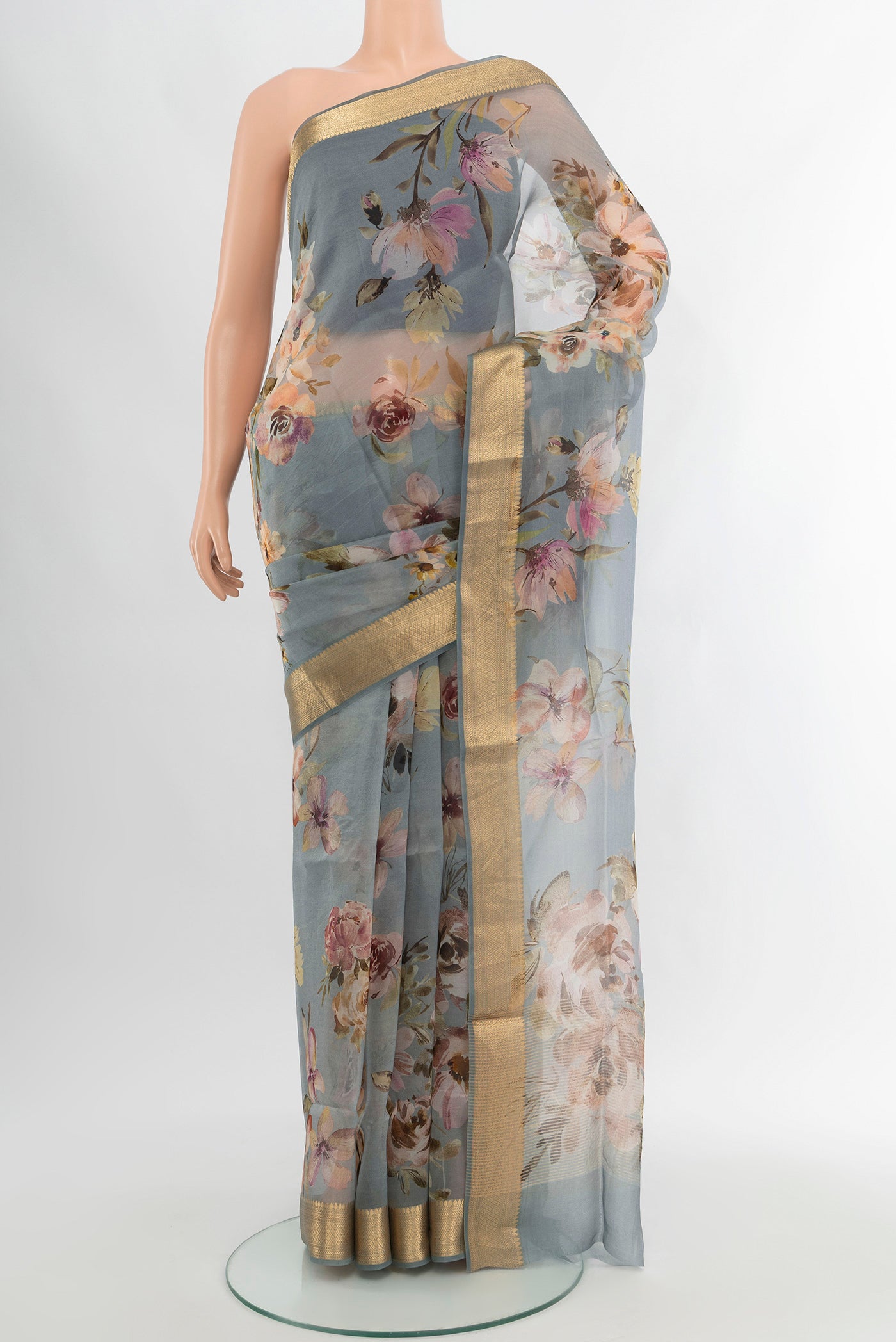 Davys Grey Organza Silk Saree with Floral Print on the body and Zari Border.  displayed on a mannequin