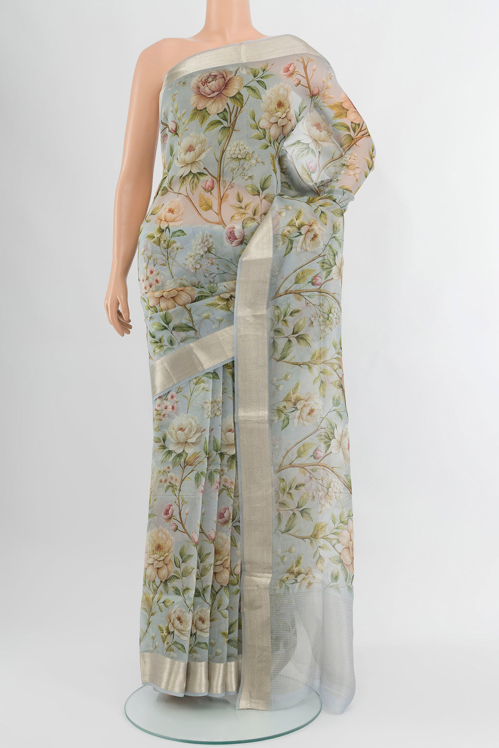 Light Blue Organza Silk Saree with Floral Print on the body and Zari Border.  displayed on a mannequin