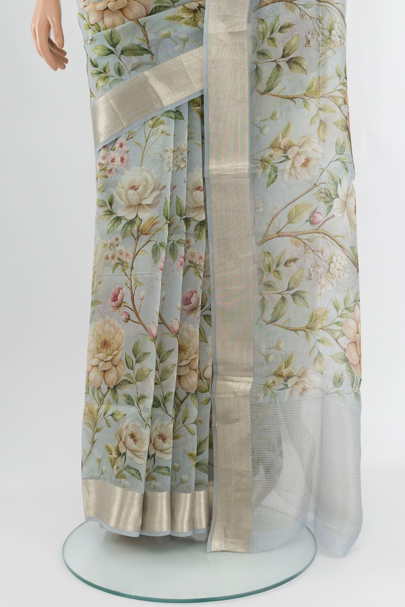 Pleats and pallu of Light Blue Organza Silk Saree with Floral Print on the body and Zari Border. 