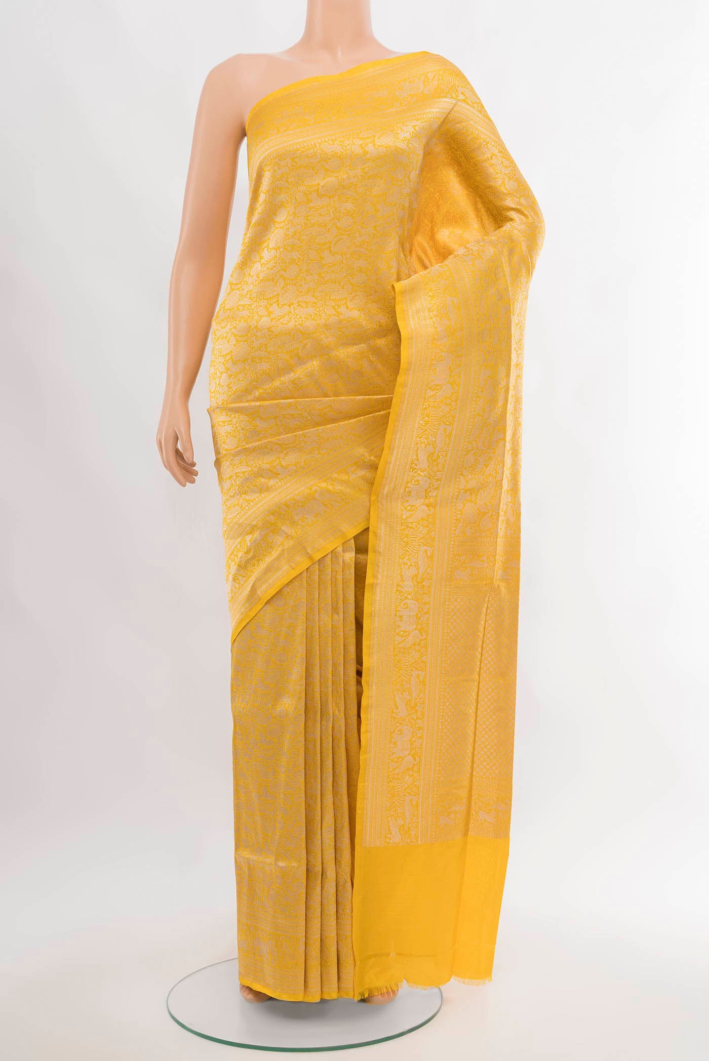 Yellow Banarasi Silk Saree with Zari Butta on the body and Silk Border.  displayed on a mannequin