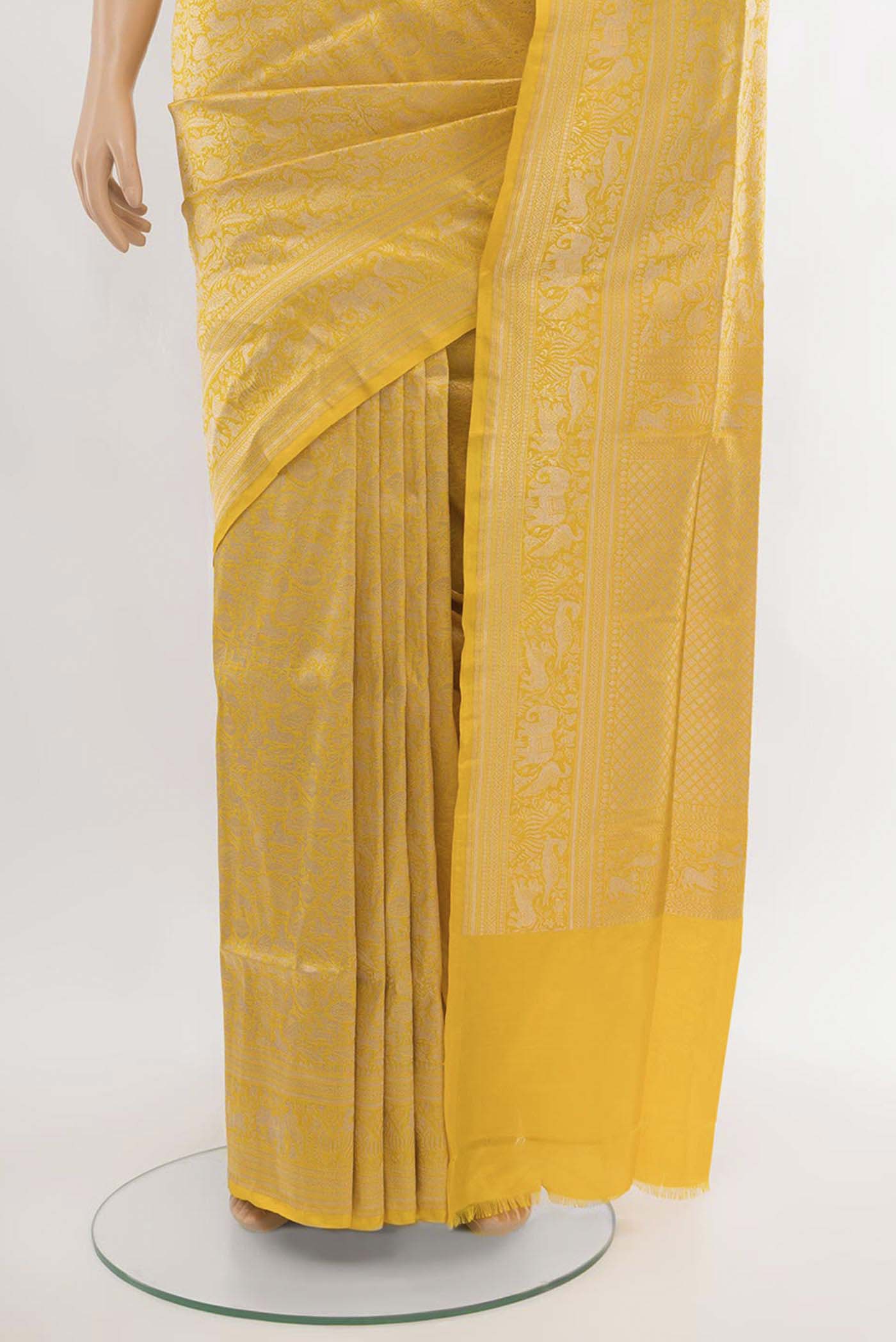 Pleats and pallu of Yellow Banarasi Silk Saree with Zari Butta on the body and Silk Border. 