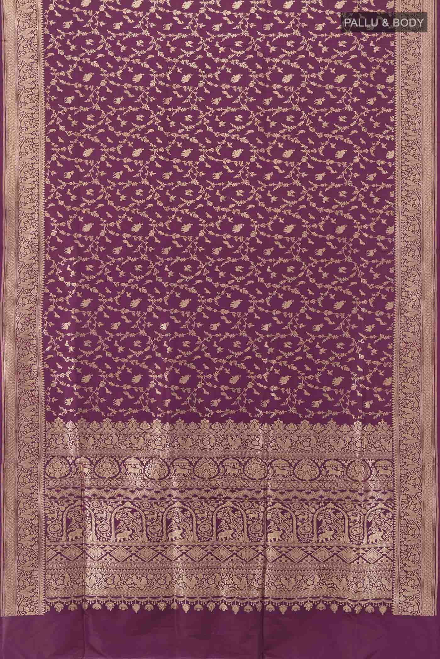 Flat view of Purple Banarasi Silk Saree with Zari Butta on the body and Silk Border. 