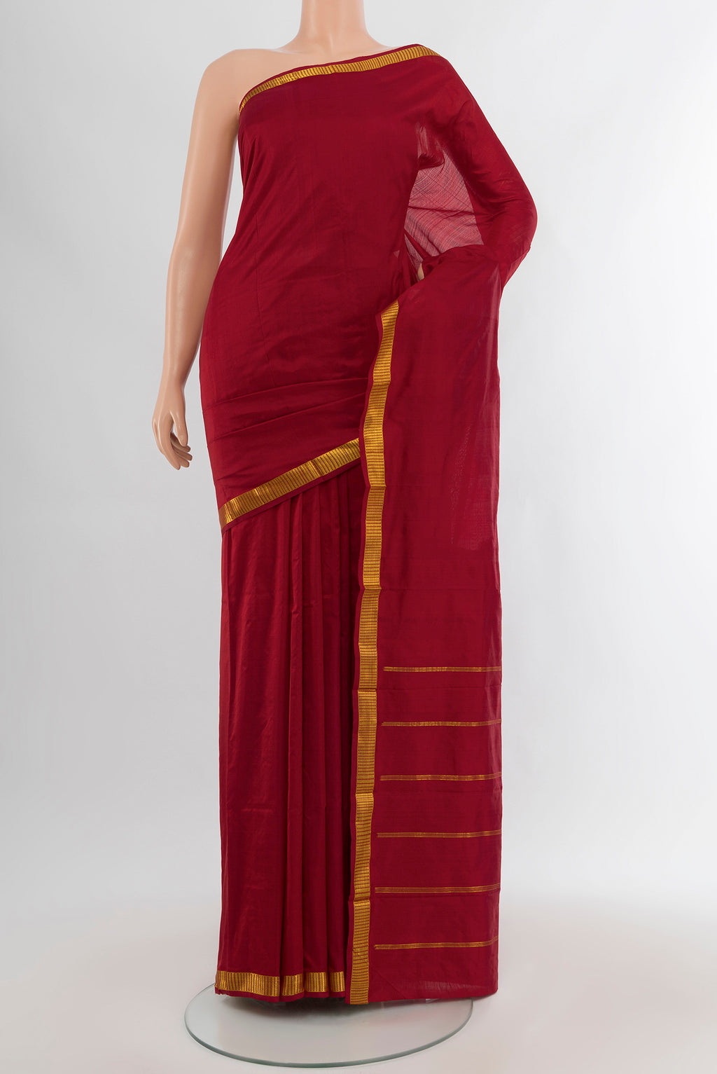 Maroon Kanchipuram Silk Saree with Plain Body and Zari Border.  displayed on a mannequin