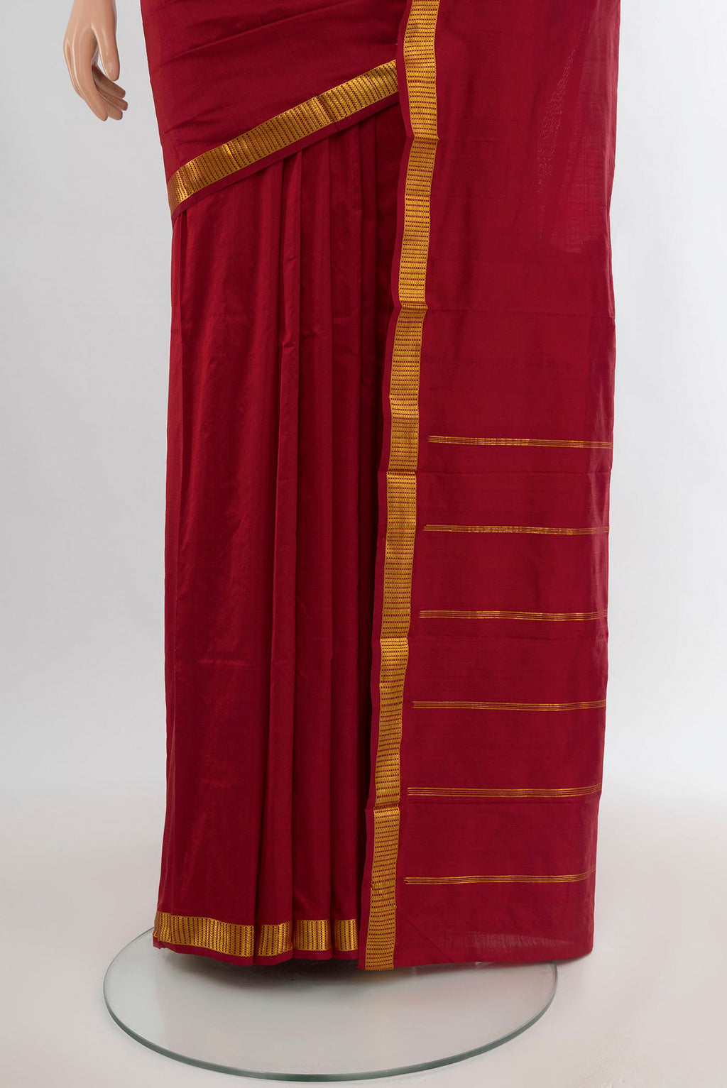 Pleats and pallu of Maroon Kanchipuram Silk Saree with Plain Body and Zari Border. 
