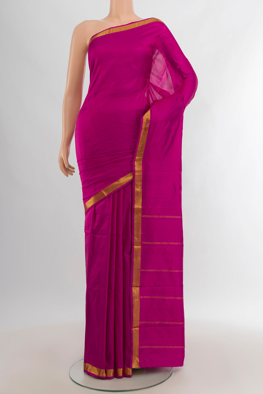 Magenta Kanchipuram Silk Saree with Plain Body and Zari Border.  displayed on a mannequin