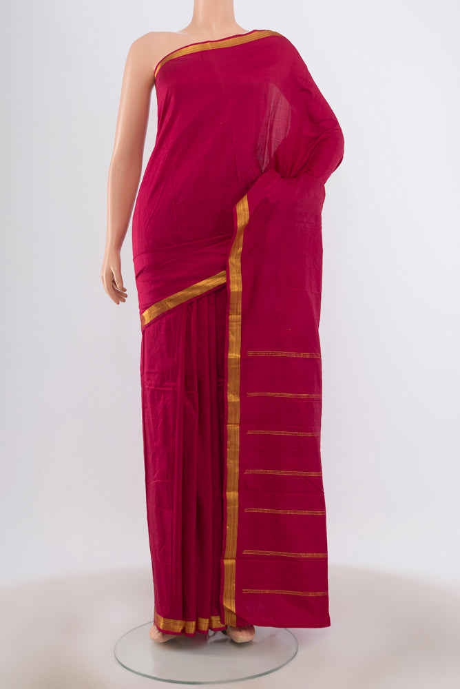 Maroon Kanchipuram Silk Saree with Zari Butta on the body and Silk Border.  displayed on a mannequin