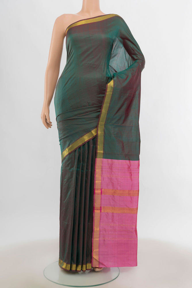 Mehandi Green Kanjivaram Silk Saree with Zari Butta on the body and Silk Border.  displayed on a mannequin