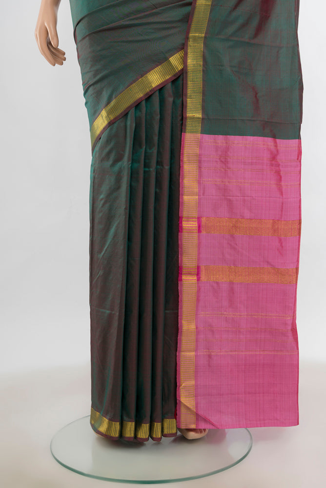 Pleats and pallu of Mehandi Green Kanjivaram Silk Saree with Zari Butta on the body and Silk Border. 