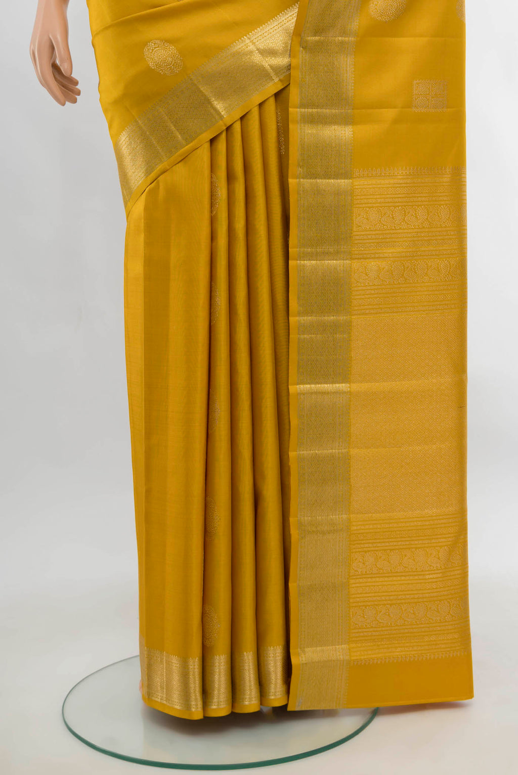 Pleats and pallu of Yellow Kanjivaram Silk Saree with Zari Butta on the body and Silk Border. 