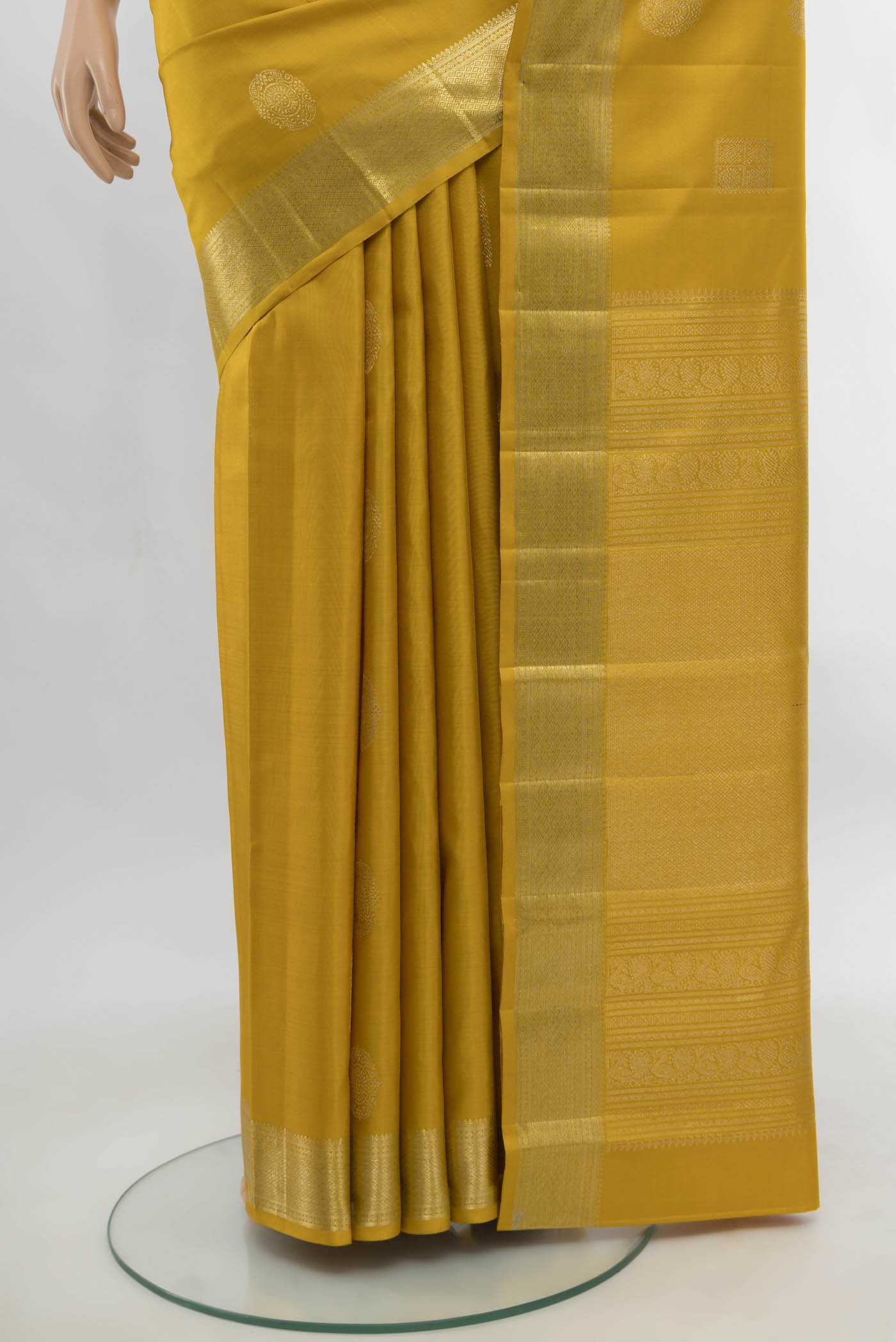 Pleats and pallu of Yellow Kanjivaram Silk Saree with Zari Butta on the body and Silk Border. 
