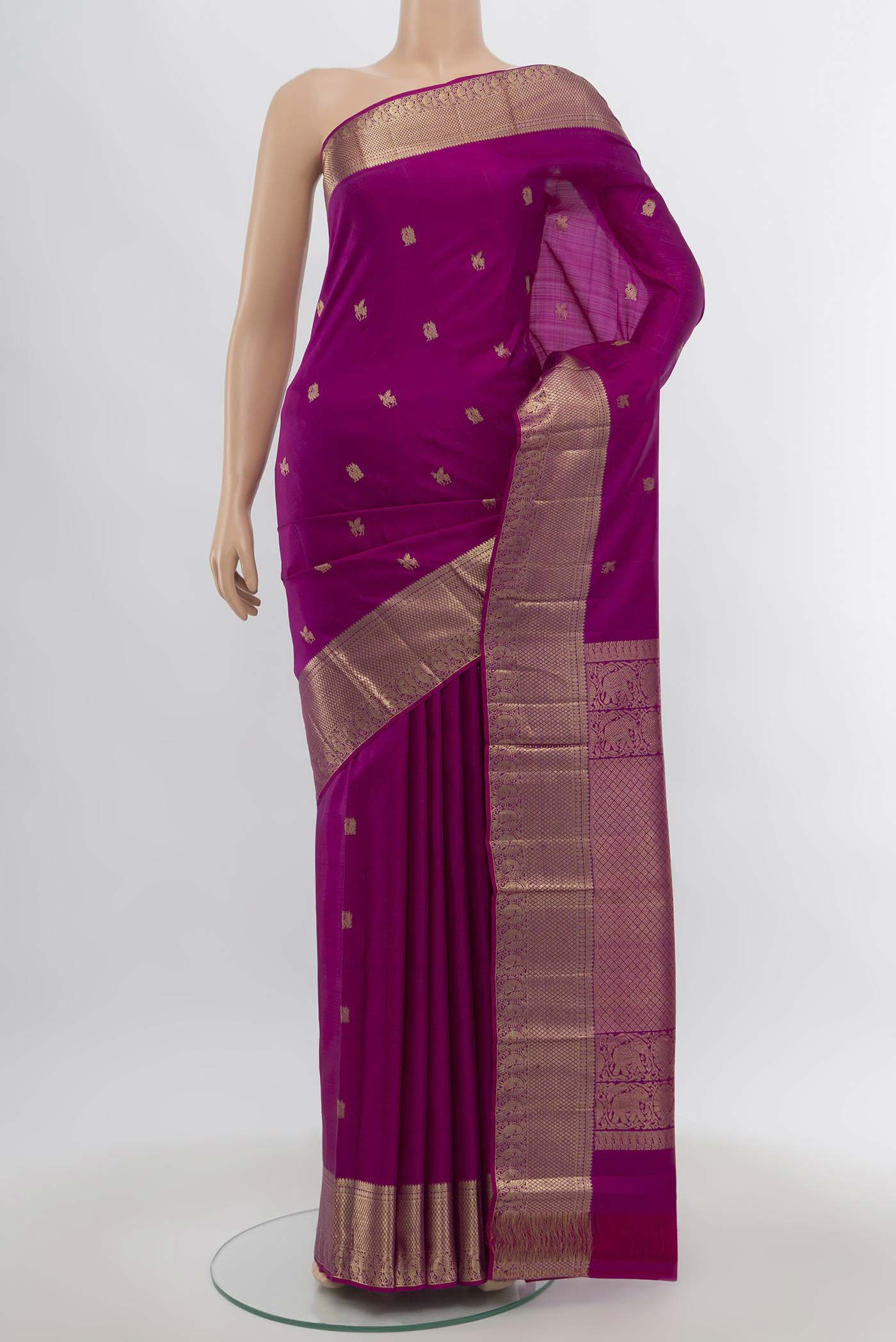 Purple Kanjivaram Silk Saree with Zari Butta on the body and Silk Border.  displayed on a mannequin